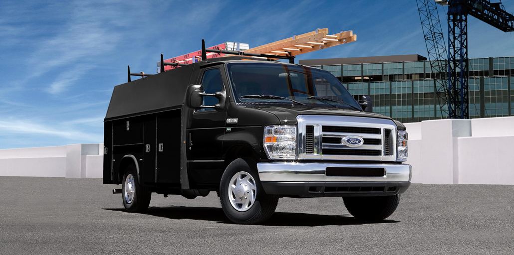 Ford E-series service body hauling ladders on top of vehicle